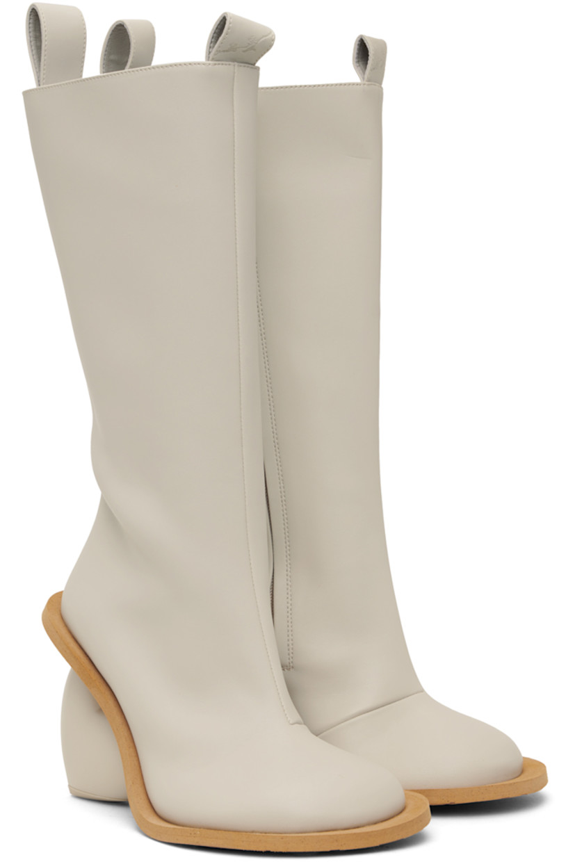 Calf-high buffed faux-leather boots in off-white. 

· Pull-loops at collar
· Zip closure at inner side
· Logo embossed at heel tab
· Sculptural heel with rubber injection
· Foam rubber sole
· Heel: H3.75"

Available exclusively at SSENSE.

Supplier color: Rainday