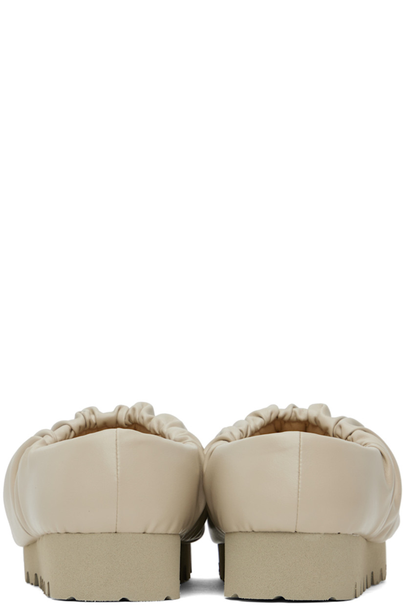 Padded buffed faux-leather slip-on loafers in beige.

· Gathering at collar
· Logo stamp at padded footbed
· Treaded EVA foam rubber platform sole
· Platform: H1.5"

Supplier color: Beige vegan leather