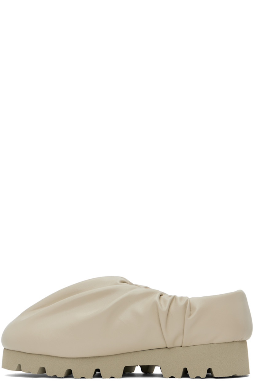 Padded buffed faux-leather slip-on loafers in beige.

· Gathering at collar
· Logo stamp at padded footbed
· Treaded EVA foam rubber platform sole
· Platform: H1.5"

Supplier color: Beige vegan leather