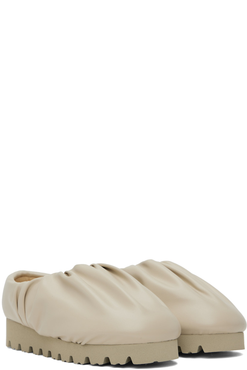 Padded buffed faux-leather slip-on loafers in beige.

· Gathering at collar
· Logo stamp at padded footbed
· Treaded EVA foam rubber platform sole
· Platform: H1.5"

Supplier color: Beige vegan leather