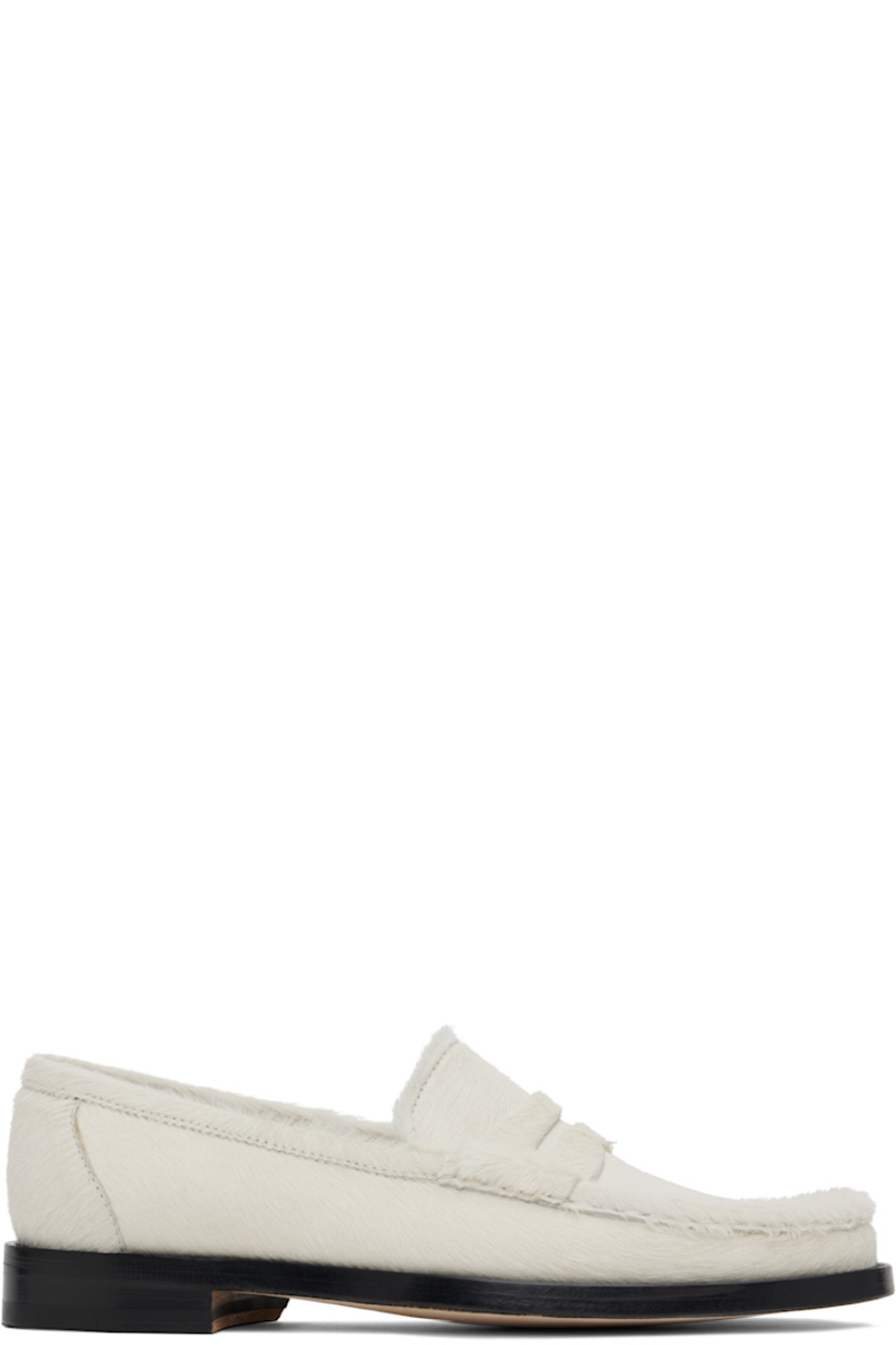 Calf hair loafers in off-white. 

· Moc toe 
· Strap with cutout at vamp
· Logo patch at padded footbed
· Buffed leather lining
· Stacked leather midsole 
· Calfskin sole with rubber injection 

Supplier color: Ivory