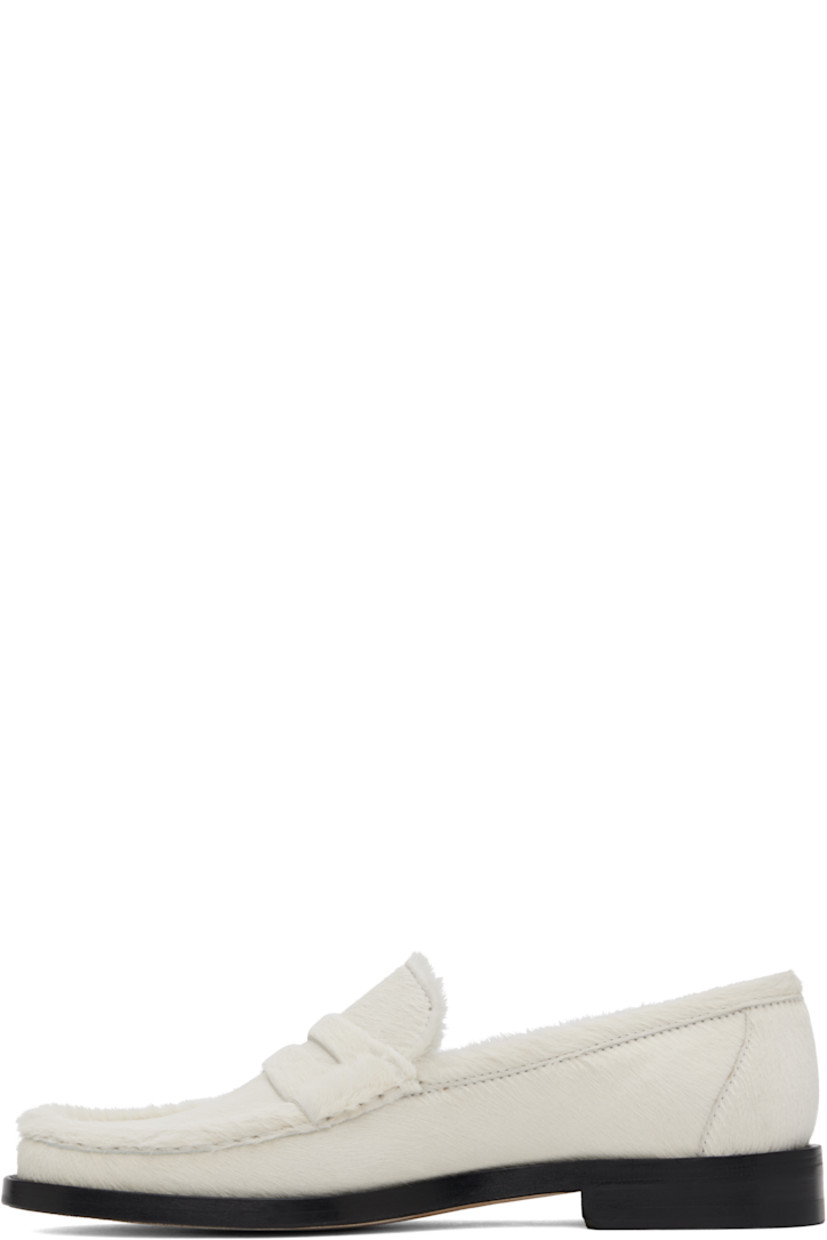 Calf hair loafers in off-white. 

· Moc toe 
· Strap with cutout at vamp
· Logo patch at padded footbed
· Buffed leather lining
· Stacked leather midsole 
· Calfskin sole with rubber injection 

Supplier color: Ivory
