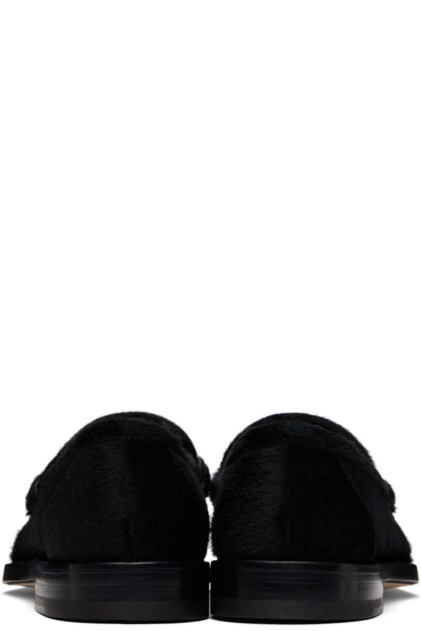 Calf-hair loafers in black.

· Moc toe
· Strap with cutout at vamp
· Logo patch at leather footbed 
· Suede and buffed leather lining
· Stacked leather heel with rubber injection
· Calfskin nubuck sole 

Supplier color: Black