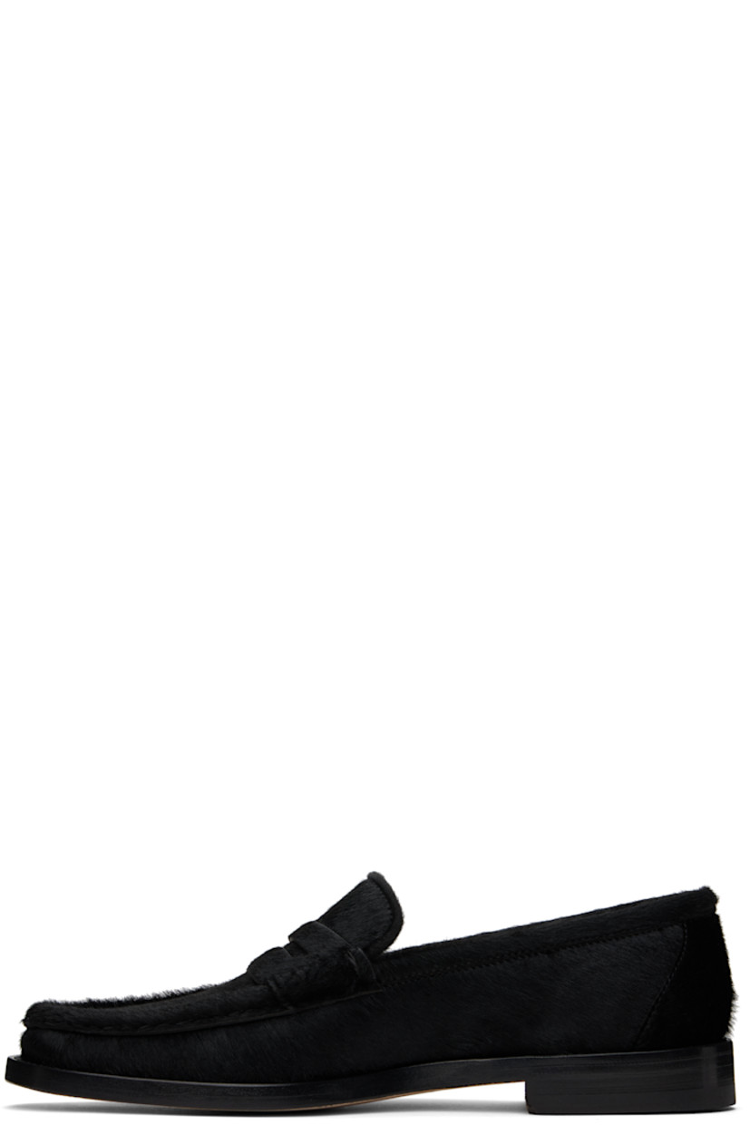 Calf-hair loafers in black.

· Moc toe
· Strap with cutout at vamp
· Logo patch at leather footbed 
· Suede and buffed leather lining
· Stacked leather heel with rubber injection
· Calfskin nubuck sole 

Supplier color: Black