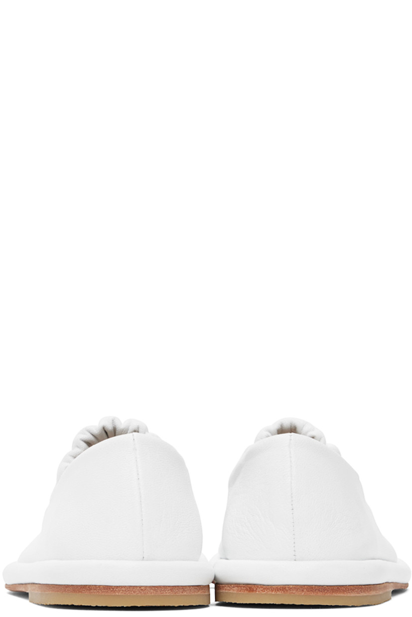 Handcrafted grained leather ballerina flats in white.

· Ruched elasticized strap at vamp
· Grained leather lining
· Covered midsole
· Crepe rubber heel
· Leather sole

Supplier color: White