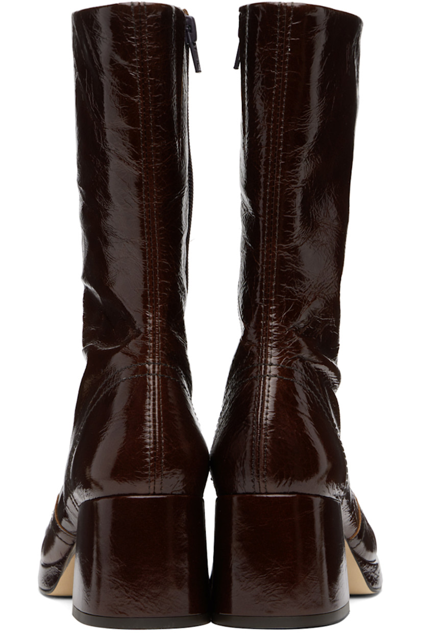 Handcrafted mid-calf crinkled patent leather boots in brown.

· Square toe
· Central seam at vamp
· Zip closure at inner side
· Buffed leather lining
· Covered block heel with rubber injection
· Covered platform midsole
· Nubuck sole with rubber injection
· Platform: H0.5"
· Heel: H2.25"

Supplier color: Brown patent
