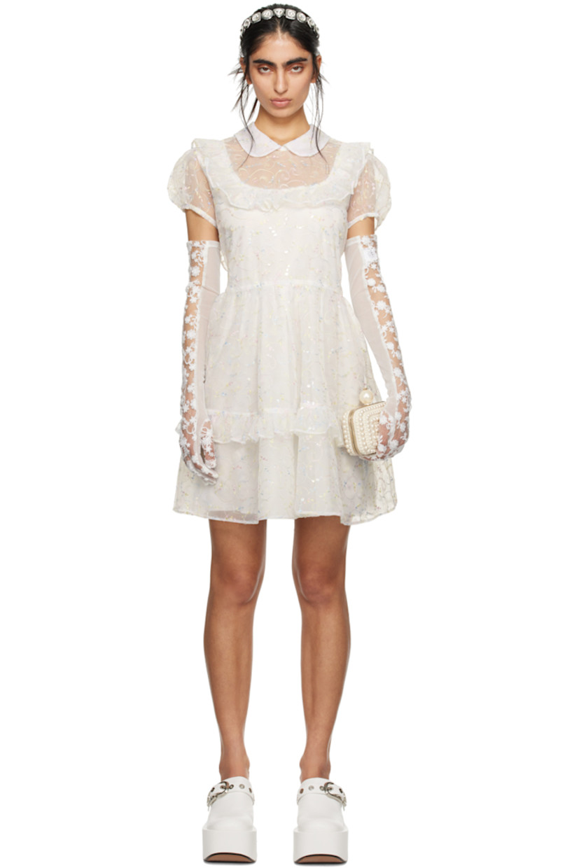 Semi-sheer polyester organza dress. Ruffles, sequins, and graphic metallic thread detailing throughout.

· Tiered construction
· Peter Pan collar
· Puff sleeves 
· Zip closure at back collar
· Self-tie bow at back waist
· Full crepe lining 

Part of the exclusive SSENSE Bridal capsule.

Supplier color: Cream multi