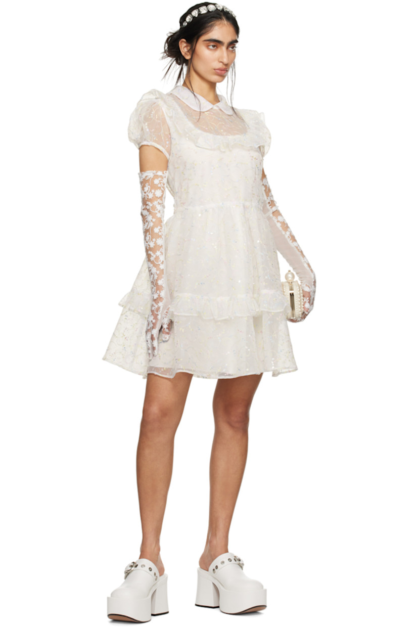Semi-sheer polyester organza dress. Ruffles, sequins, and graphic metallic thread detailing throughout.

· Tiered construction
· Peter Pan collar
· Puff sleeves 
· Zip closure at back collar
· Self-tie bow at back waist
· Full crepe lining 

Part of the exclusive SSENSE Bridal capsule.

Supplier color: Cream multi