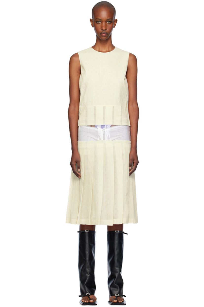 Cotton broadcloth minidress.

· Scoop neck
· Transparent PVC panel and raw edges at waist
· Knife pleats at hem
· Concealed zip closure at back
· Unlined

Supplier color: Ecru
