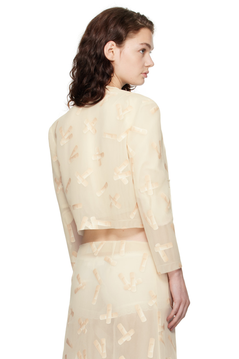 Semi-sheer double-faced polyethylene mesh jacket. Graphic pattern printed throughout. 

· Raw edge at crewneck, hem, and cuffs
· Press-stud closure
· Patch pockets 

Supplier color: Ecru