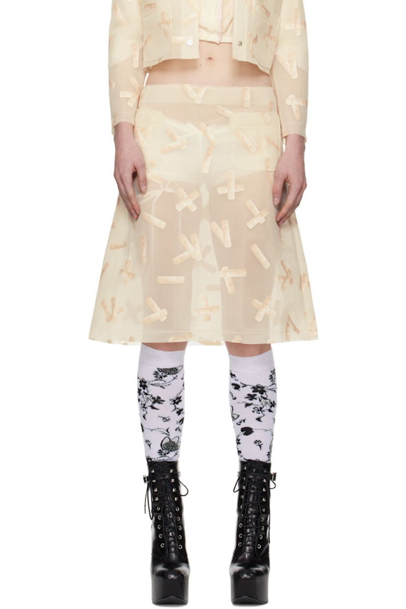 Semi-sheer double-faced polyethylene mesh midi skirt. Graphic pattern printed throughout. 

· Raw edge at waistband and hem
· Darts at front and back
· Patch pockets at front 
· Concealed zip closure at side seam 

Supplier color: Ecru