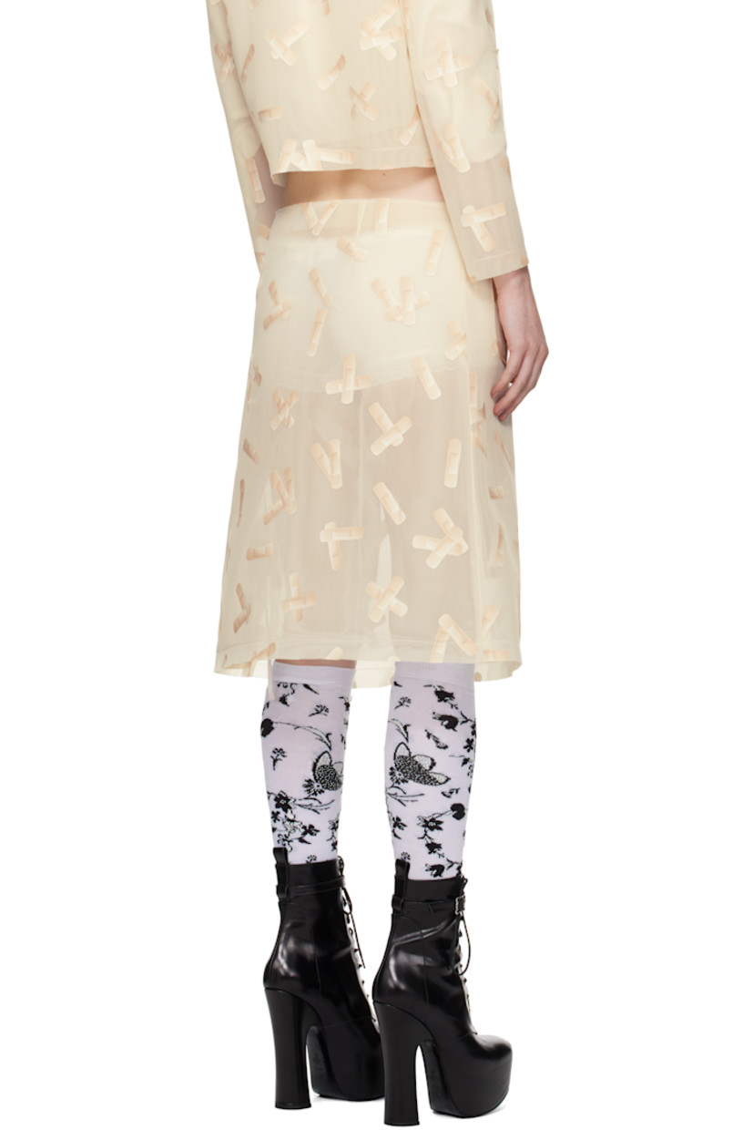 Semi-sheer double-faced polyethylene mesh midi skirt. Graphic pattern printed throughout. 

· Raw edge at waistband and hem
· Darts at front and back
· Patch pockets at front 
· Concealed zip closure at side seam 

Supplier color: Ecru