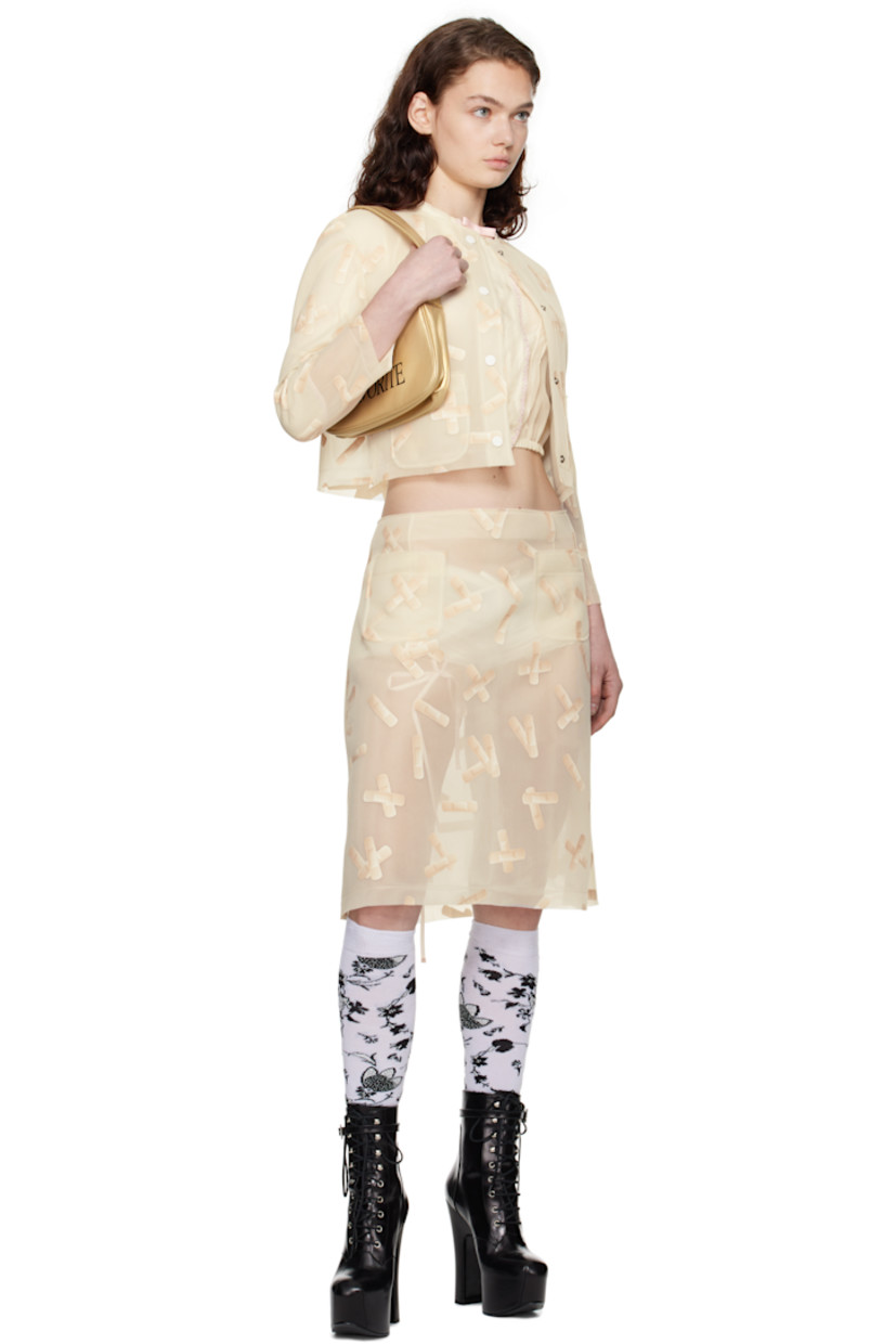 Semi-sheer double-faced polyethylene mesh midi skirt. Graphic pattern printed throughout. 

· Raw edge at waistband and hem
· Darts at front and back
· Patch pockets at front 
· Concealed zip closure at side seam 

Supplier color: Ecru