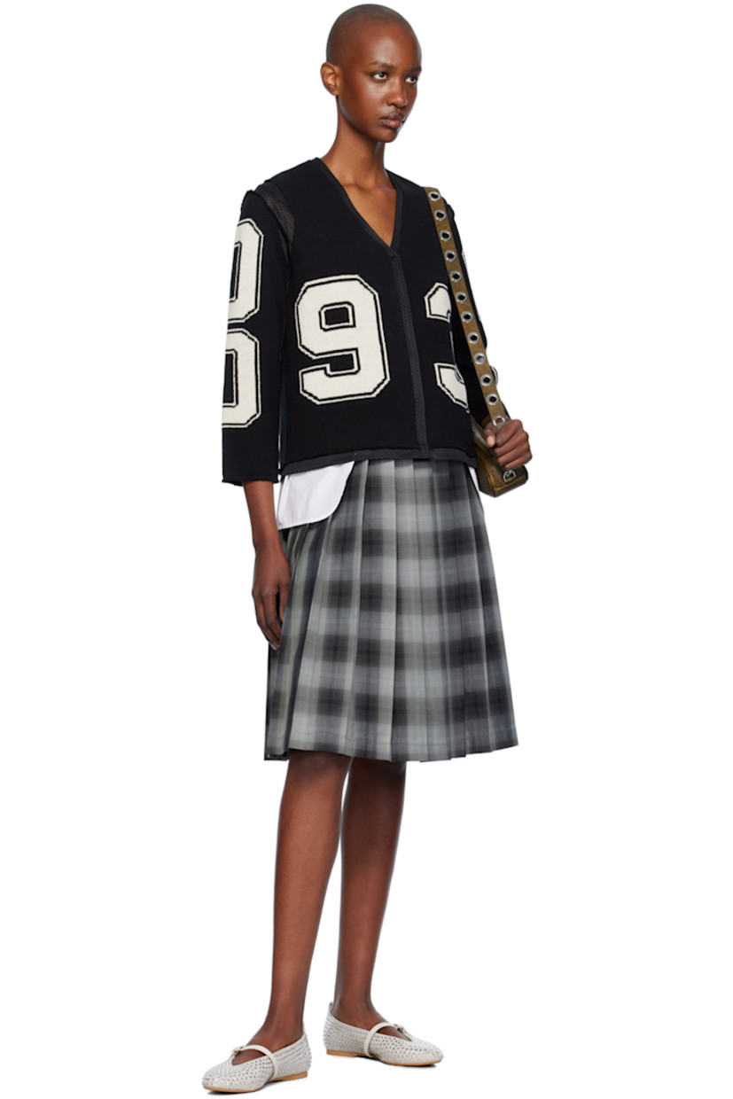 Knit merino lambswool and polyester mesh cardigan. Raw edges and intarsia text throughout.

· Paneled construction
· Y-neck
· Press-stud closure
· Full mesh lining

Supplier color: Black