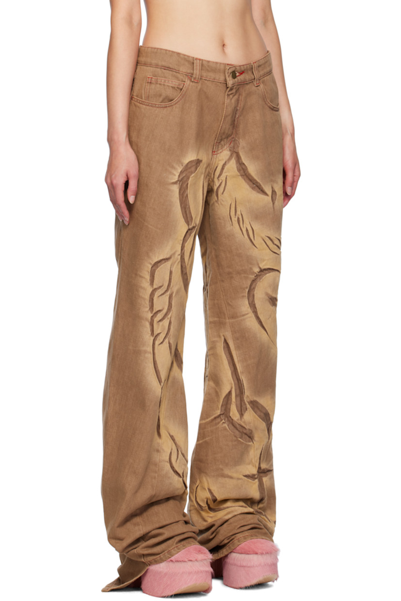 Non-stretch pre-consumer recycled cotton-blend denim jeans. Fading, creasing, and graphics throughout.

· Belt loops
· Five-pocket styling
· Zip-fly
· Twisted inseams and outseams
· Asymmetric cuffs
· Contrast stitching in red

Available exclusively at SSENSE.

Supplier color: Mocha fossil