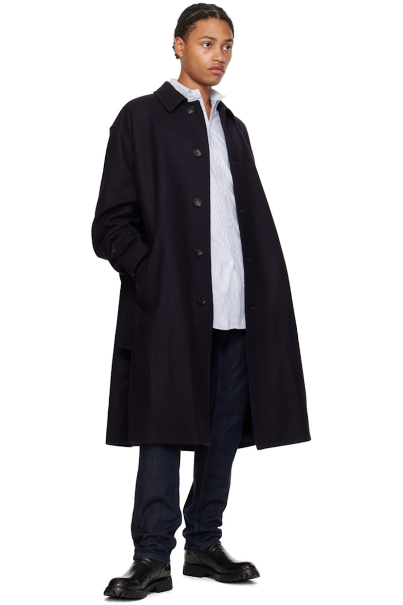 Brushed virgin wool coat.

· Spread collar
· Button closure
· Welt pockets
· Belt loops and detachable pin-buckle belt
· Adjustable button tab at cuffs
· Logo flag at cuff
· Welt pockets at interior
· Full satin lining

Supplier color: Navy