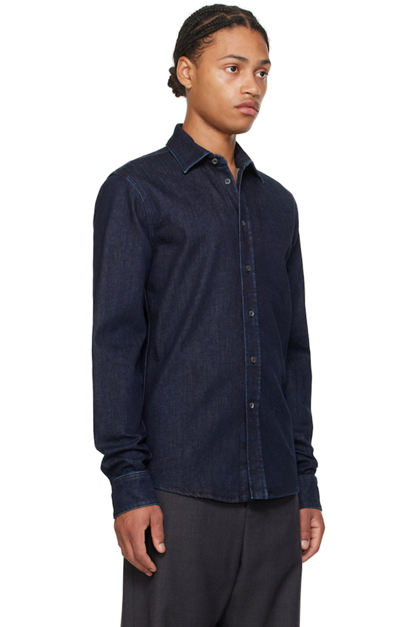 Stretch denim shirt.

· Spread collar
· Button closure
· Shirttail hem
· Single-button barrel cuffs
· Logo-engraved mother-of-pearl hardware

Part of the Travel Collection, within the Bally x Adrien Brody collaboration.

Supplier color: Dark blue wash