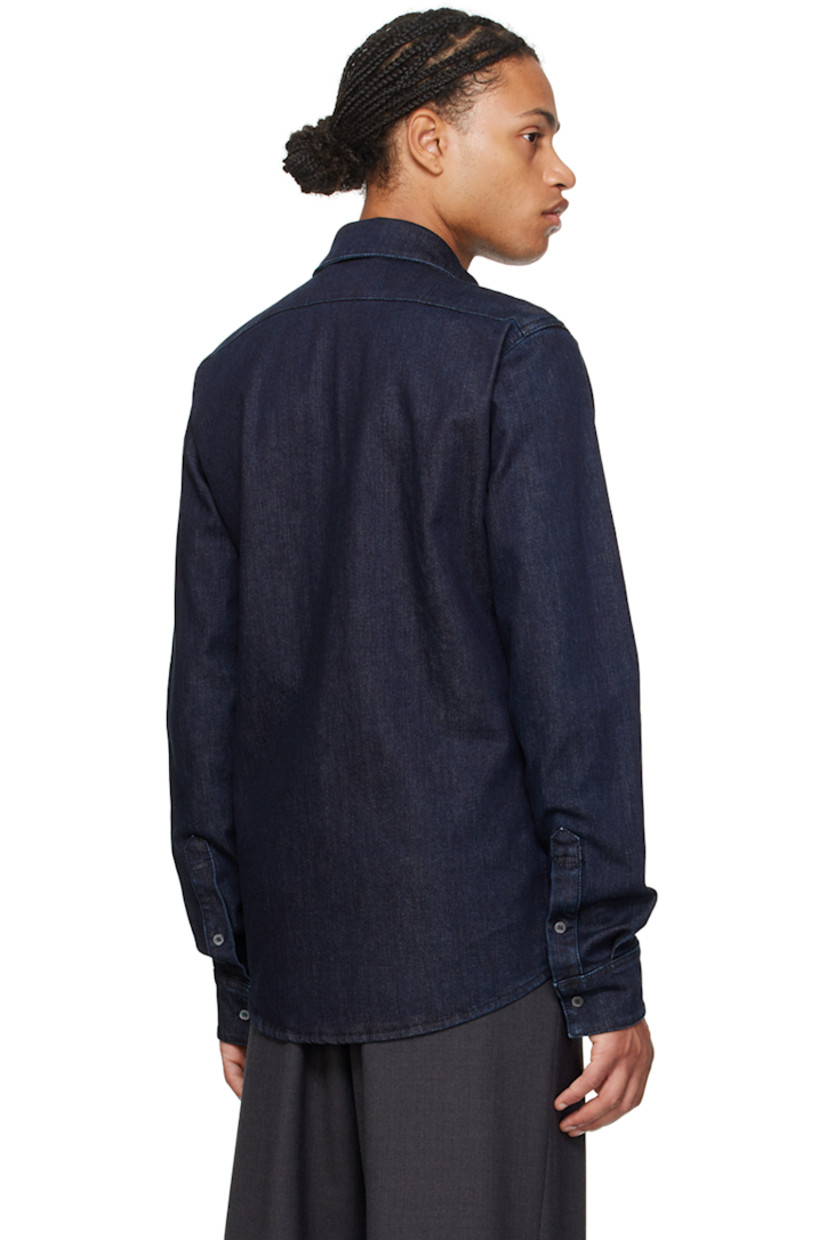 Stretch denim shirt.

· Spread collar
· Button closure
· Shirttail hem
· Single-button barrel cuffs
· Logo-engraved mother-of-pearl hardware

Part of the Travel Collection, within the Bally x Adrien Brody collaboration.

Supplier color: Dark blue wash