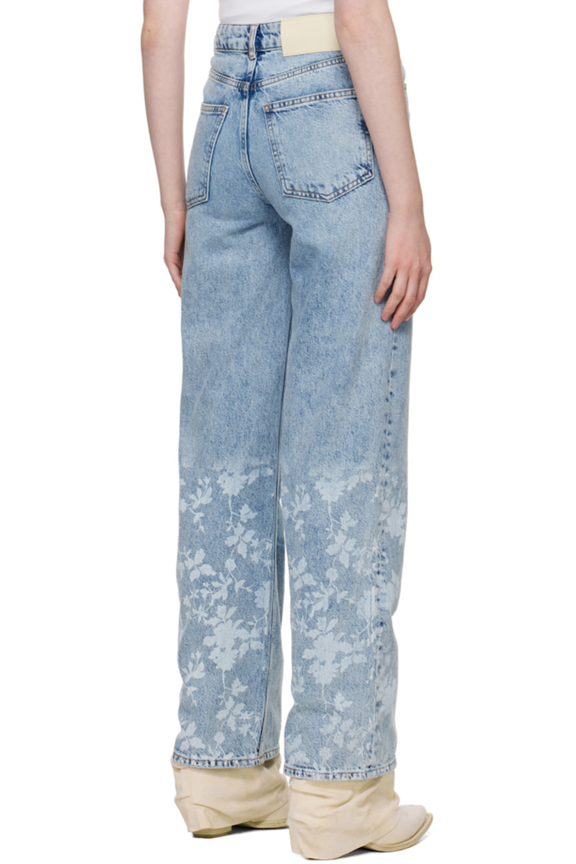Wide-leg non-stretch organic cotton denim jeans. Fading and whiskering throughout.

· High-rise
· Belt loops
· Five-pocket styling
· Zip-fly
· Floral pattern printed at cuffs
· Leather logo patch at back waistband
· Logo-engraved silver-tone hardware
· Contrast stitching in tan

Supplier color: Mid blue