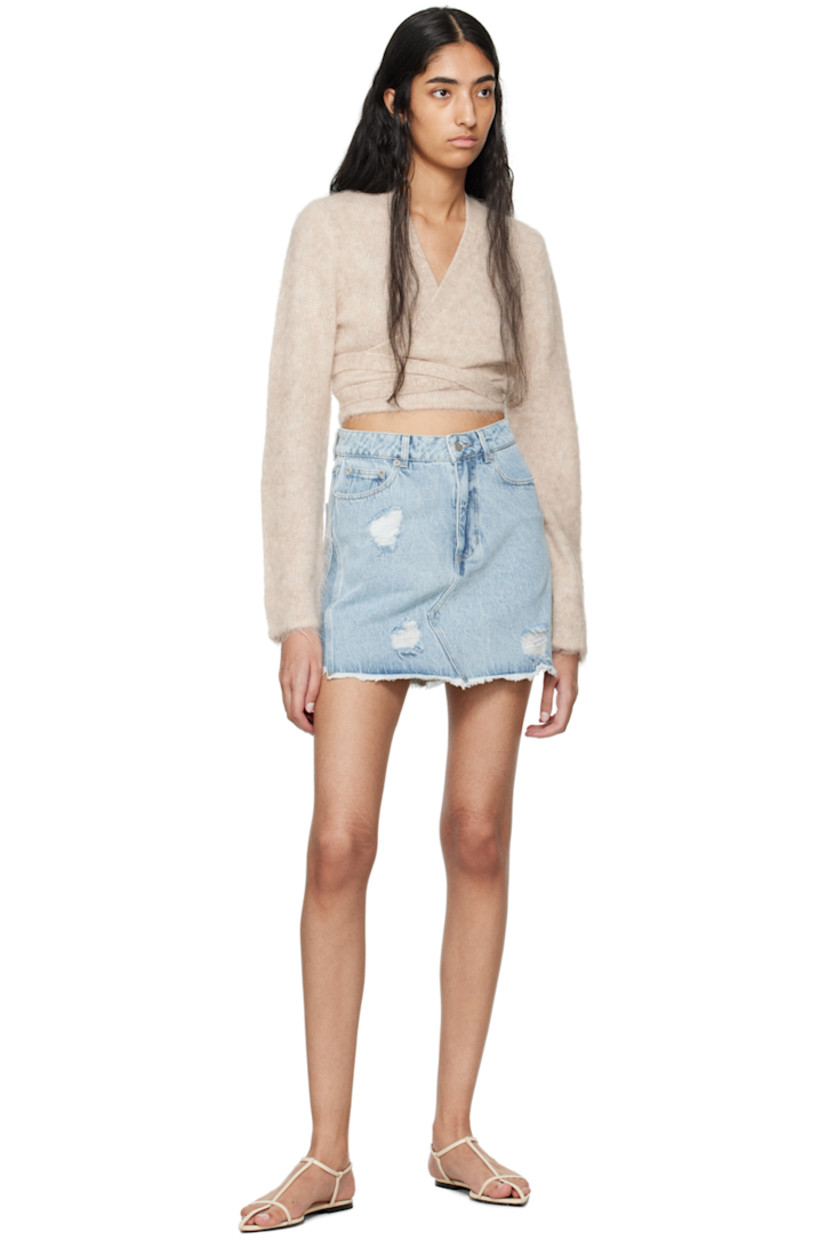 A-line non-stretch denim skirt. Distressing and fading throughout. 

· Mid-rise
· Belt loops 
· Five-pocket styling 
· Zip-fly 
· Raw edge at hem 
· Jacron logo patch at back waistband 
· Contrast stitching in tan 
· Unlined 

Supplier color: Light blue mix