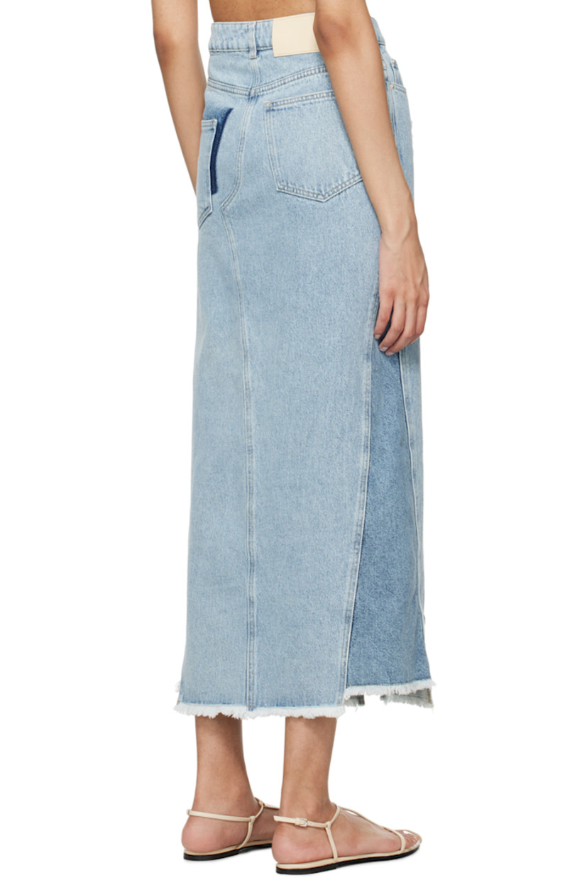 Non-stretch denim skirt. Fading and distressing throughout. 

· Mid-rise
· Belt loops 
· Five-pocket styling 
· Zip-fly 
· Vented front hem 
· Raw edge at hem 
· Jacron logo patch at back waistband 
· Silver-tone logo-engraved hardware 
· Contrast stitching in tan 

Supplier color: Light blue mix