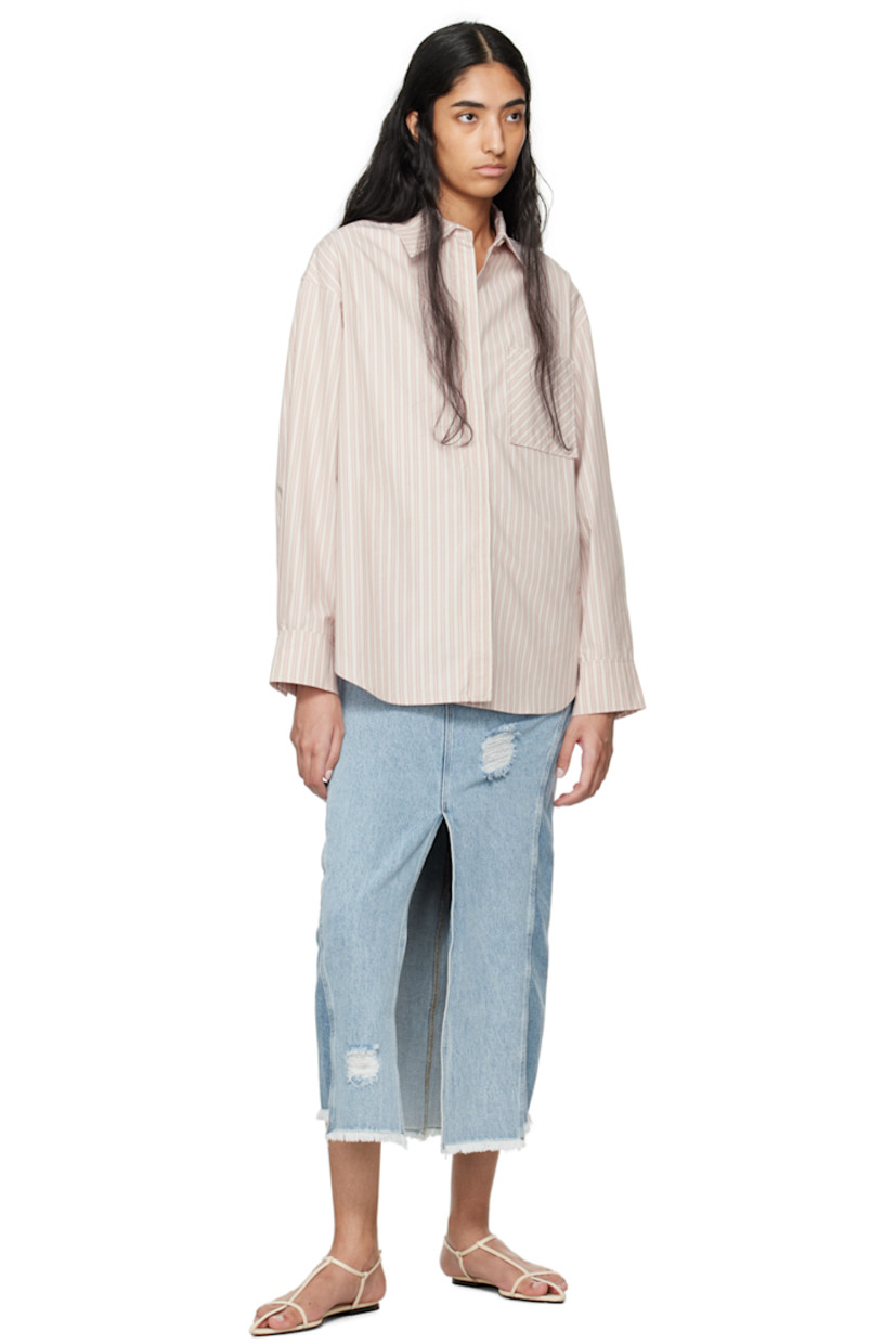 Non-stretch denim skirt. Fading and distressing throughout. 

· Mid-rise
· Belt loops 
· Five-pocket styling 
· Zip-fly 
· Vented front hem 
· Raw edge at hem 
· Jacron logo patch at back waistband 
· Silver-tone logo-engraved hardware 
· Contrast stitching in tan 

Supplier color: Light blue mix