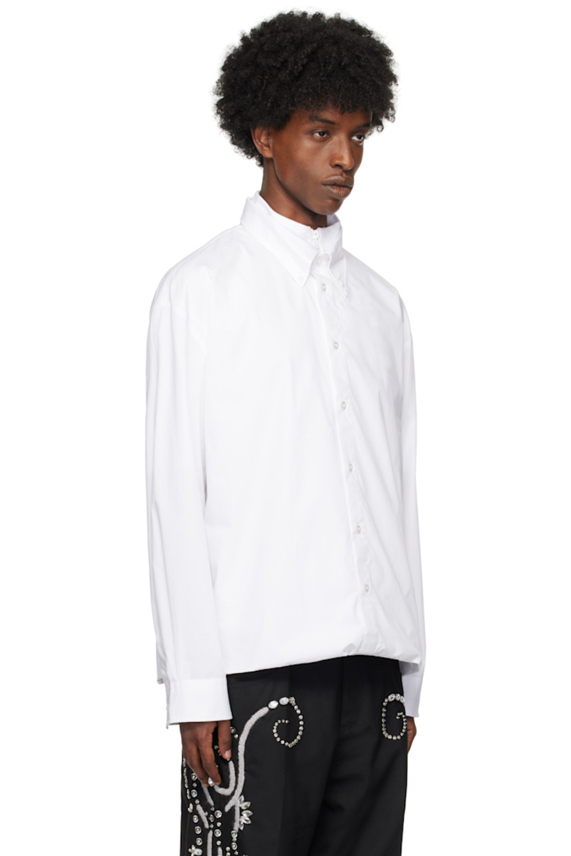 Poplin cotton shirt.

· Layered construction
· Short sleeves
· Rib-knit stand collar with half-zip placket
· Logo patch at chest
· Single-piece bodice
· Integrated long-sleeve shirt overlay
· Button-down spread collar at overlay
· Button placket and barrel cuffs
· Box pleat at back

Supplier color: White