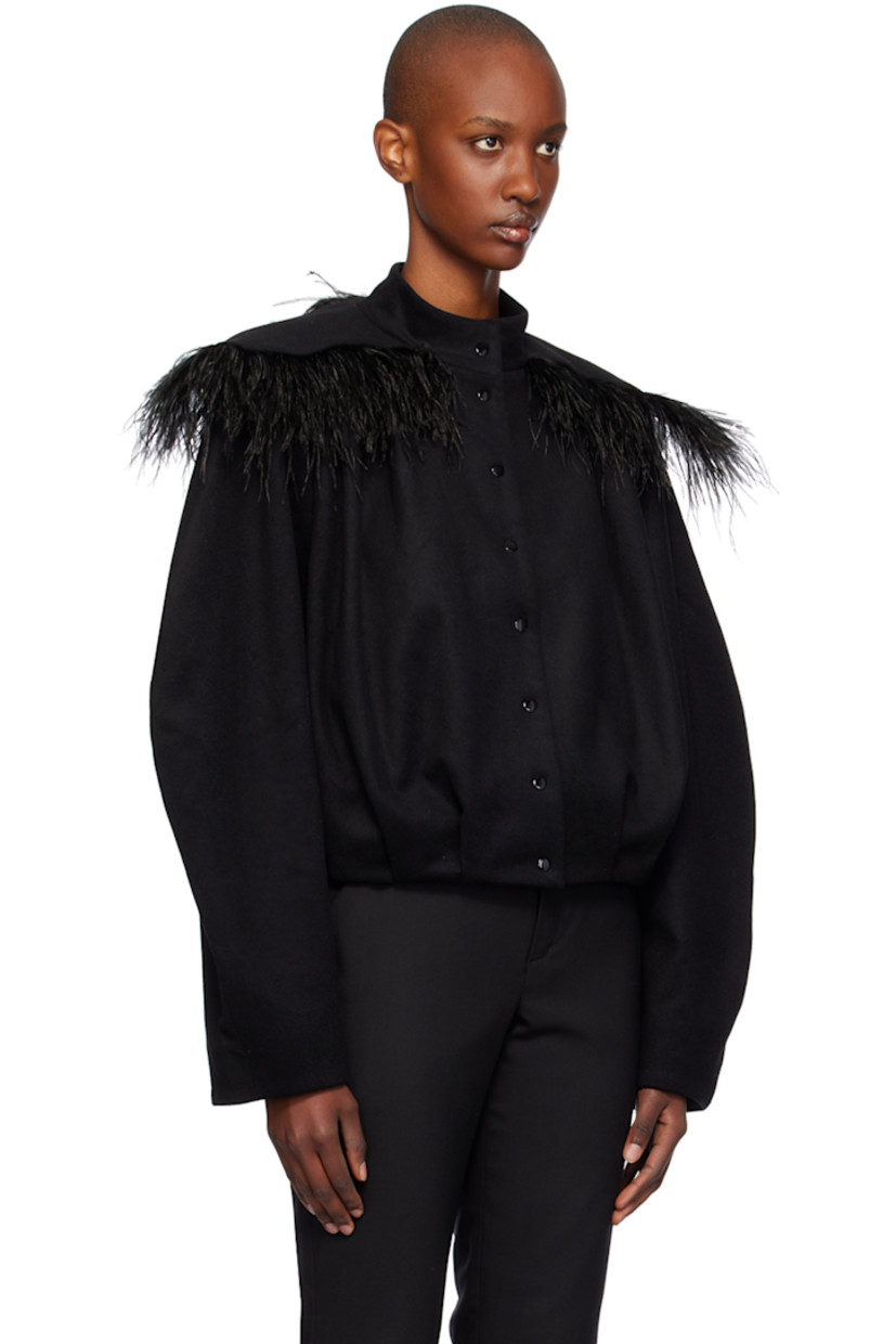 Wool flannel jacket. 

· Stand collar
· Press-stud closure
· Ostrich feather trim at yoke 
· Welt pockets
· Pleats at hem
· Padded shoulders
· Viscose twill lining

Supplier color: Black/Feather detail 

Trim: 100% ostrich feather.