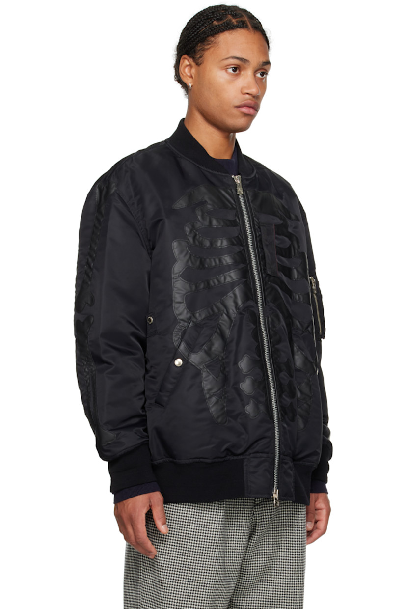 Insulated nylon satin bomber jacket. Faux-leather graphic appliqués throughout.

· Rib-knit stand collar, hem, and cuffs 
· Two-way zip closure
· Press-stud tabs at front
· Welt pockets 
· Dropped shoulders
· Utility pocket at sleeve
· Welt pockets at interior
· Fully lined
· Logo-engraved silver-tone hardware

Supplier color: Black/Black bone
