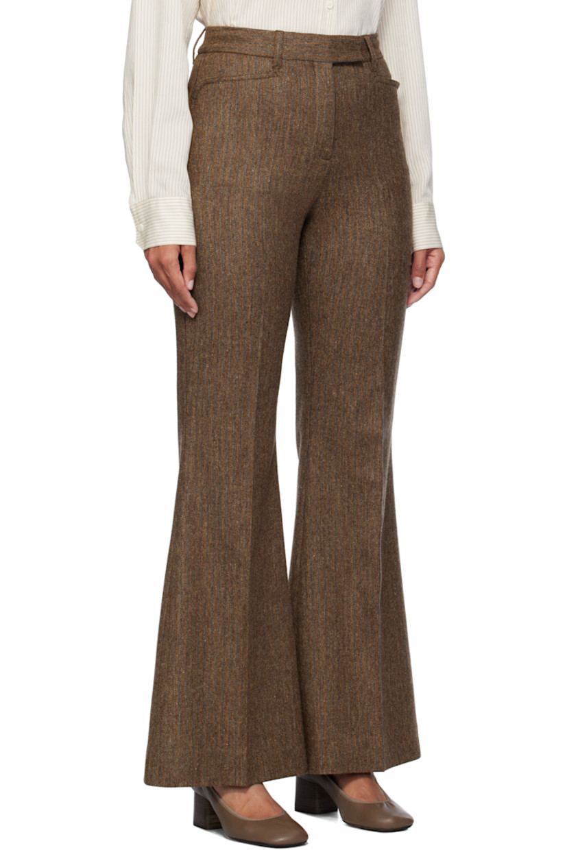 Flared merino wool tweed trousers. Herringbone pattern throughout.

· Belt loops
· Four-pocket styling
· Zip-fly
· Creased legs
· Unfinished hem
· Partial stretch satin lining

Supplier color: Carafe brown