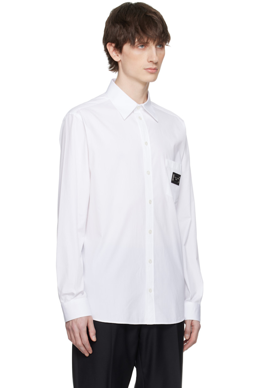 Cotton poplin shirt.

· Spread collar
· Button closure
· Patch pocket 
· Logo plaque with leather trim at chest
· Pleats at single-button barrel cuffs
· Box pleat at back yoke

Part of the Essential collection

Supplier color: Bianco ottico