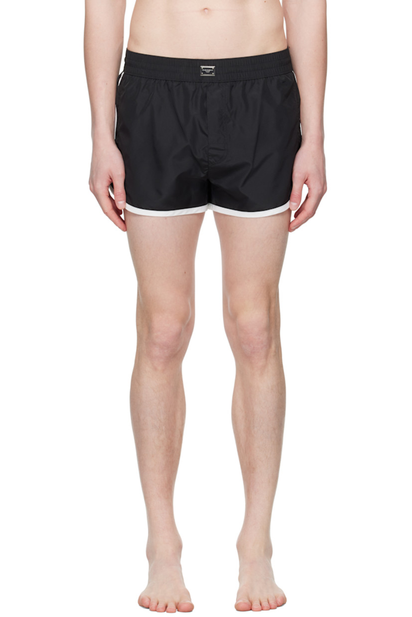 Polyester satin swim shorts. 

· Concealed drawstring at elasticized waistband
· Logo plaque at front waistband
· Three-pocket styling
· Mock fly 
· Brief-style stretch jersey lining

Supplier color: Multicolor