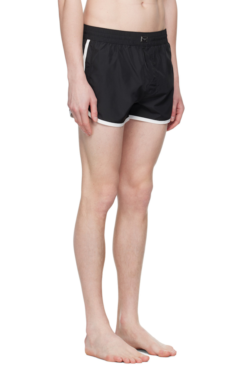 Polyester satin swim shorts. 

· Concealed drawstring at elasticized waistband
· Logo plaque at front waistband
· Three-pocket styling
· Mock fly 
· Brief-style stretch jersey lining

Supplier color: Multicolor