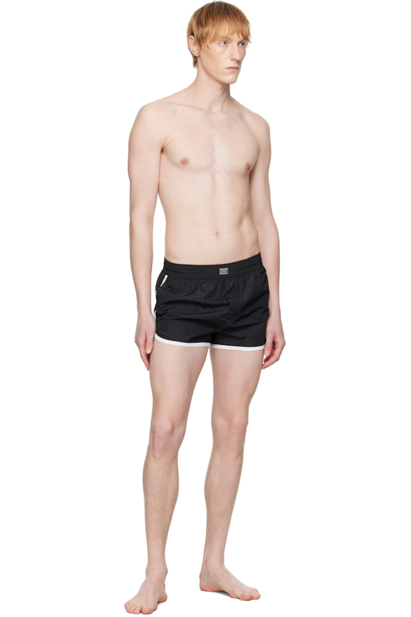 Polyester satin swim shorts. 

· Concealed drawstring at elasticized waistband
· Logo plaque at front waistband
· Three-pocket styling
· Mock fly 
· Brief-style stretch jersey lining

Supplier color: Multicolor