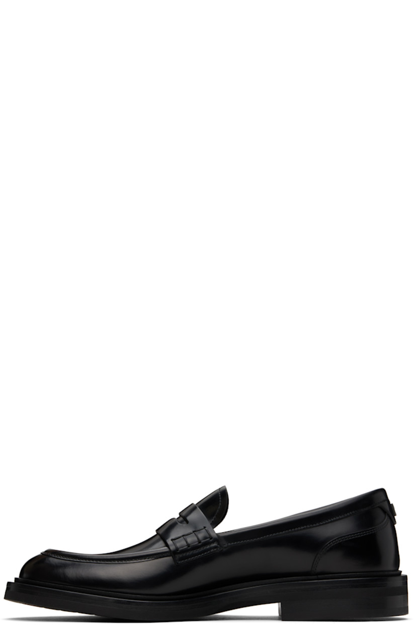 Brushed calfskin loafers in black.

· Moc toe
· Strap with cutout at vamp
· Silver-tone logo hardware at heel counter
· Buffed calfskin and suede lining
· Stacked leather heel with rubber injection 
· Treaded rubber sole

Supplier color: Nero
