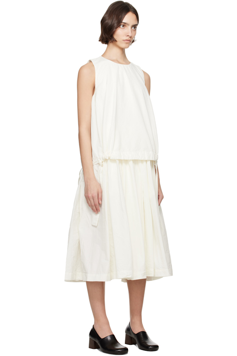 Crinkled cotton poplin midi dress.

· Layered construction
· Round neck
· Drawstrings at layered hem 
· Gathering at waist and armscyes
· Seam pockets at waist
· Button fastening at back collar
· Corozo hardware

Supplier color: Off-White