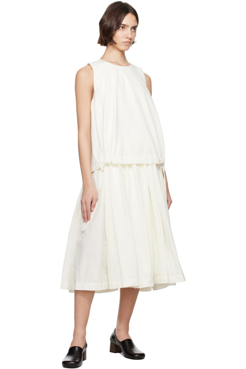 Crinkled cotton poplin midi dress.

· Layered construction
· Round neck
· Drawstrings at layered hem 
· Gathering at waist and armscyes
· Seam pockets at waist
· Button fastening at back collar
· Corozo hardware

Supplier color: Off-White
