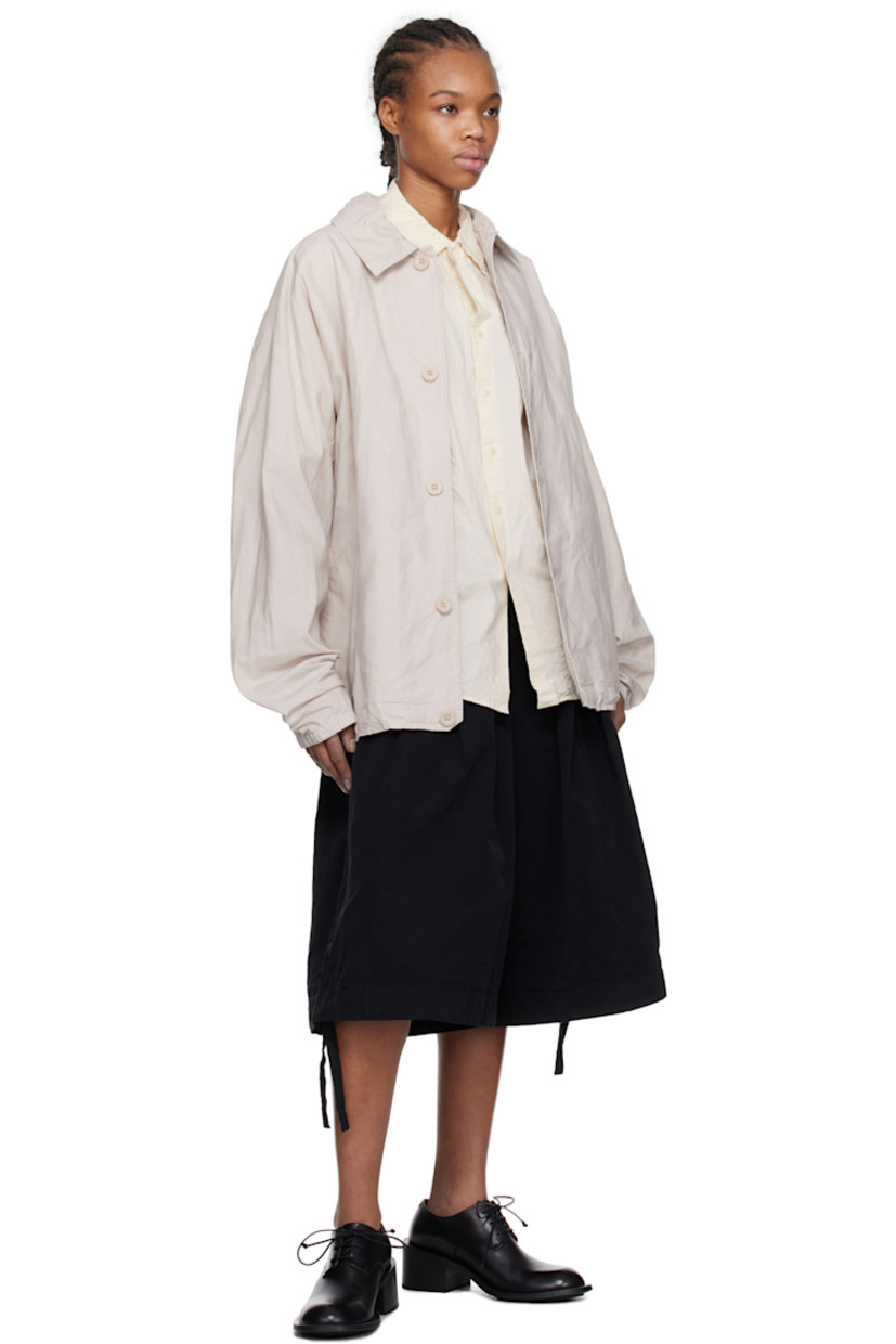 Waxed cotton broadcloth jacket.

· Spread collar
· Button closure
· Seam pockets
· Concealed drawstrings at hem
· Dolman sleeves
· Elasticized cuffs
· Storm flap at back
· Unlined 
· Corozo hardware

Supplier color: Concrete