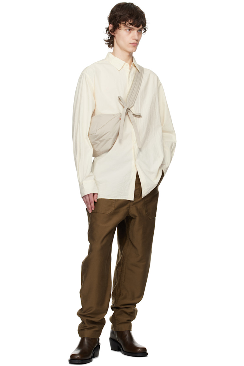Crinkled cotton poplin shirt.

· Spread collar
· Button closure
· Curved hem
· Single-button barrel cuffs
· Corozo hardware

Supplier color: Natural