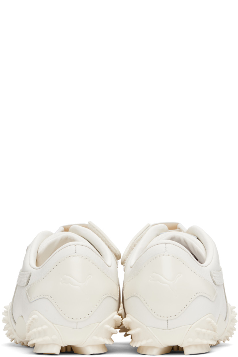 Low-top grained leather sneakers in white.

· Logo patch at offset velcro strap
· Logo patch and elasticized gusset at tongue
· Quilted Formstrip at outer side
· Logo embossed at heel counter
· Cushioned OrthoLite® footbed
· Grained faux-leather lining
· Spikes at rubber midsole
· Treaded rubber sole

Supplier color: Frosted ivory