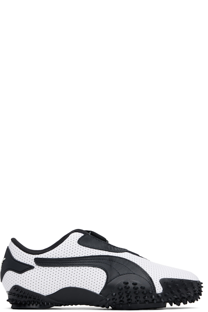 Low-top grained leather sneakers in white. 

· Perforations throughout
· Logo patch at offset velcro strap
· Logo patch and elasticized gusset at tongue
· Padded tongue and collar
· Quilted Formstrip at outer side
· Rubberized logo patch at heel counter
· Cushioned OrthoLite® footbed
· Jersey lining
· Spikes at rubber midsole
· Treaded rubber sole

Supplier color: PUMA white/PUMA black