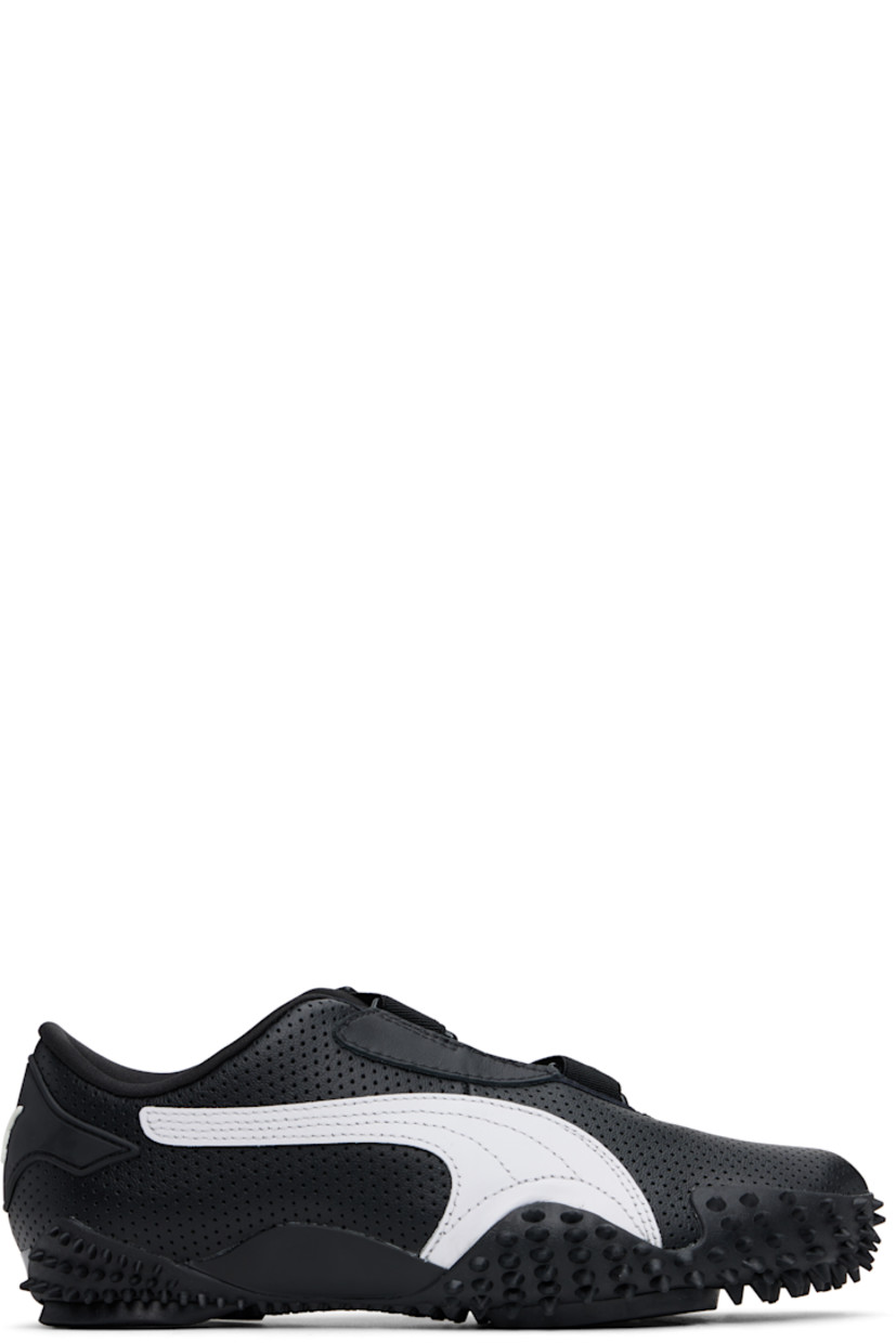 Low-top grained leather sneakers in black. 

· Perforations throughout
· Logo patch at offset velcro strap
· Logo patch and elasticized gusset at tongue
· Padded tongue and collar
· Quilted Formstrip at outer side
· Rubberized logo patch at heel counter
· Cushioned OrthoLite® footbed
· Jersey lining
· Spikes at rubber midsole
· Treaded rubber sole

Supplier color: PUMA black/PUMA white