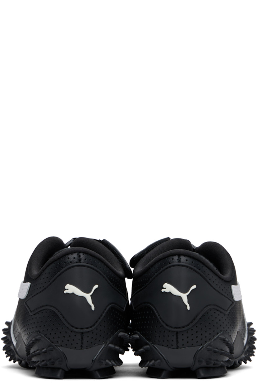 Low-top grained leather sneakers in black. 

· Perforations throughout
· Logo patch at offset velcro strap
· Logo patch and elasticized gusset at tongue
· Padded tongue and collar
· Quilted Formstrip at outer side
· Rubberized logo patch at heel counter
· Cushioned OrthoLite® footbed
· Jersey lining
· Spikes at rubber midsole
· Treaded rubber sole

Supplier color: PUMA black/PUMA white