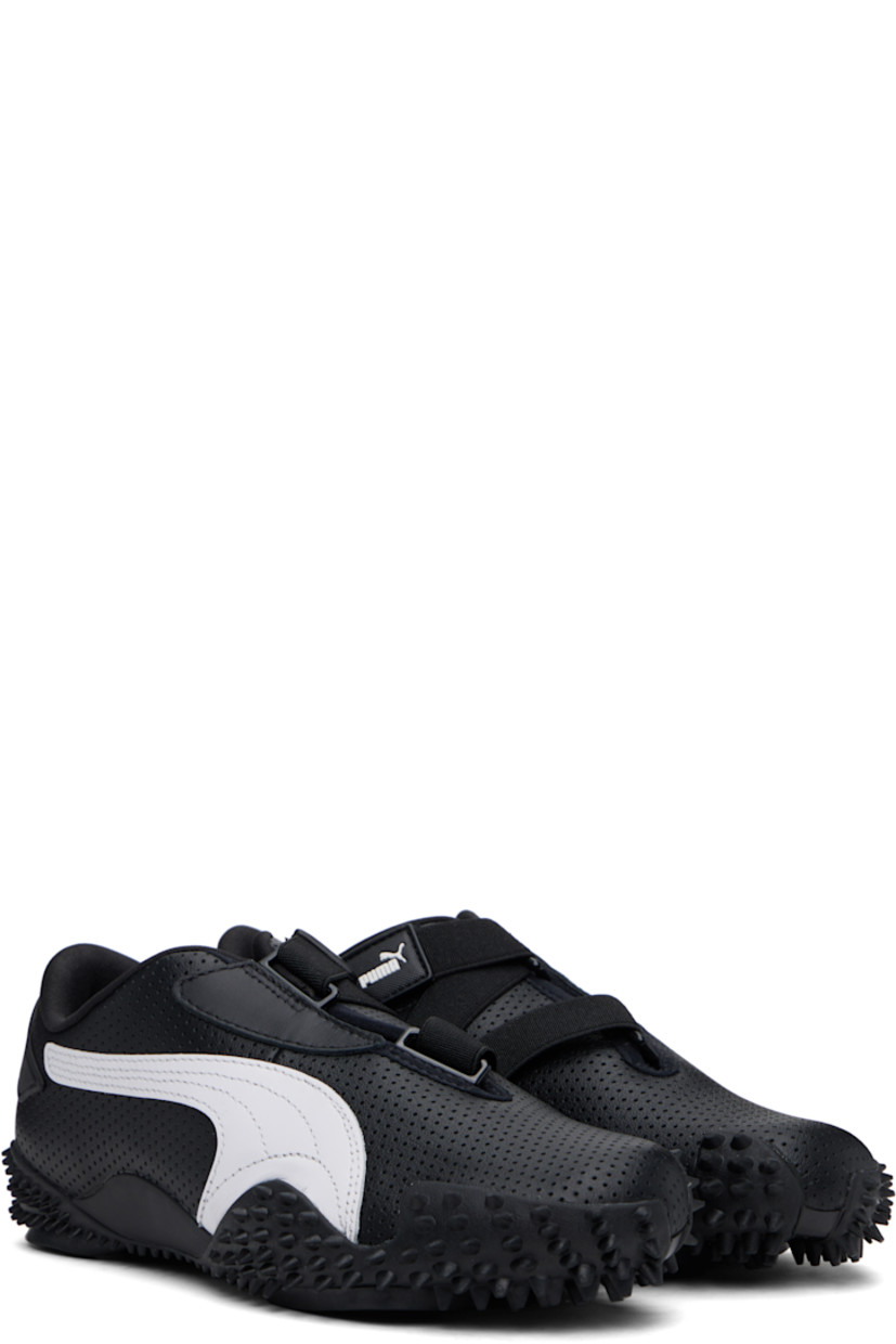 Low-top grained leather sneakers in black. 

· Perforations throughout
· Logo patch at offset velcro strap
· Logo patch and elasticized gusset at tongue
· Padded tongue and collar
· Quilted Formstrip at outer side
· Rubberized logo patch at heel counter
· Cushioned OrthoLite® footbed
· Jersey lining
· Spikes at rubber midsole
· Treaded rubber sole

Supplier color: PUMA black/PUMA white