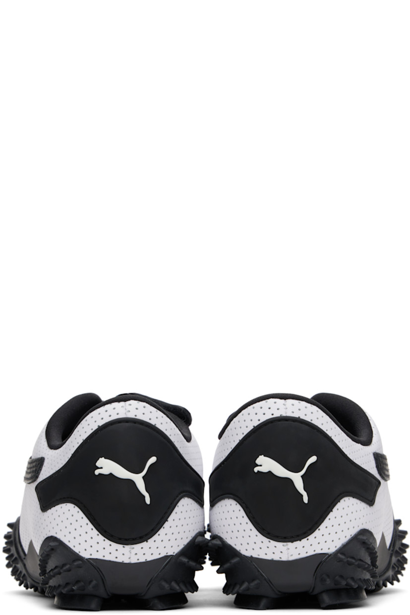 Low-top buffed leather sneakers in white. 

· Perforations throughout
· Offset velcro straps at vamp
· Logo patch at vamp and padded tongue
· Concealed elasticized gusset at tongue
· Padded collar
· Quilted formstrip at outer side
· Rubberized logo patch at heel counter
· Jersey lining
· Spikes at rubber midsole
· Treaded rubber sole

Supplier color: PUMA white/PUMA black