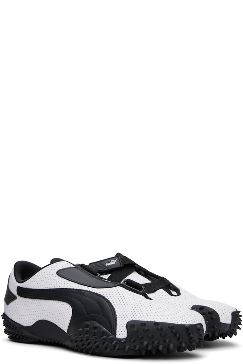 Low-top buffed leather sneakers in white. 

· Perforations throughout
· Offset velcro straps at vamp
· Logo patch at vamp and padded tongue
· Concealed elasticized gusset at tongue
· Padded collar
· Quilted formstrip at outer side
· Rubberized logo patch at heel counter
· Jersey lining
· Spikes at rubber midsole
· Treaded rubber sole

Supplier color: PUMA white/PUMA black