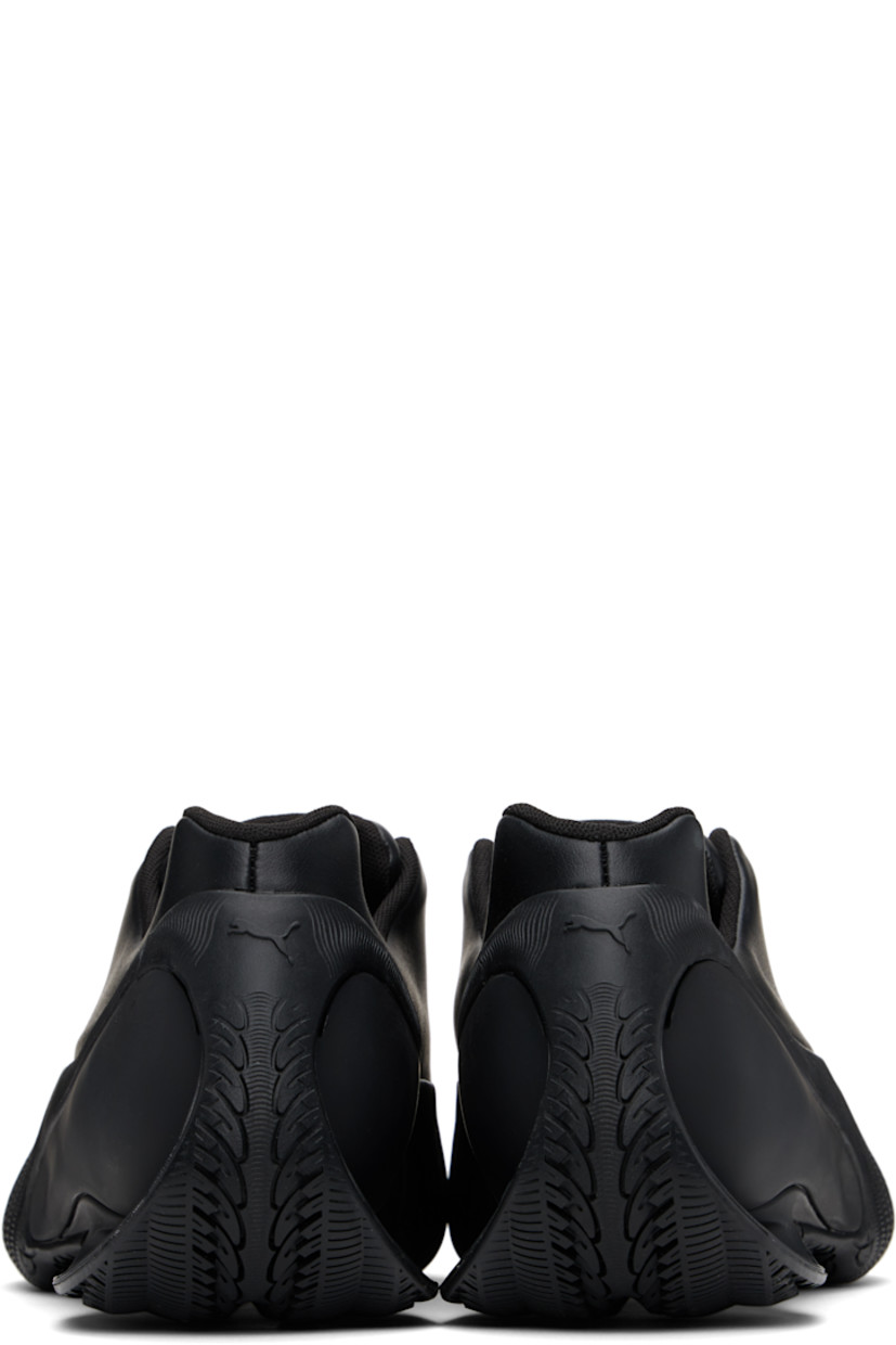 Low-top buffed faux-leather slip-on sneakers in black.  

· Logo bonded at toe
· Logo embossed at padded tongue
· Concealed velcro fastenings and elasticized gussets at tongue
· Padded collar
· Textured formstrip at sides
· Logo embossed at heel counter
· Mesh lining
· Sculptural heel with cutout
· Treaded rubber sole

Part of the Puma x Rombaut collaboration. 

Supplier color: Black