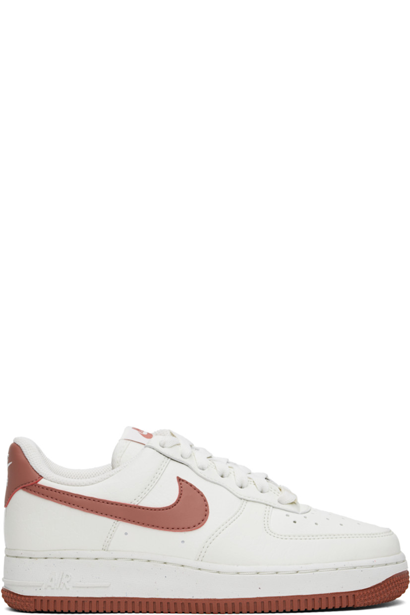 Low-top buffed leather sneakers in white and pink.

· Perforated detailing at toe and sides
· Logo plaque at lace-up closure
· Logo patch at tongue
· Padded collar
· Swoosh appliqué at sides
· Logo embroidered at heel tab
· Mesh lining
· Logo embossed at foam rubber midsole
· Treaded rubber sole

Please note that this item may be shipped only within North America.

Supplier color: Sail/Canyon pink