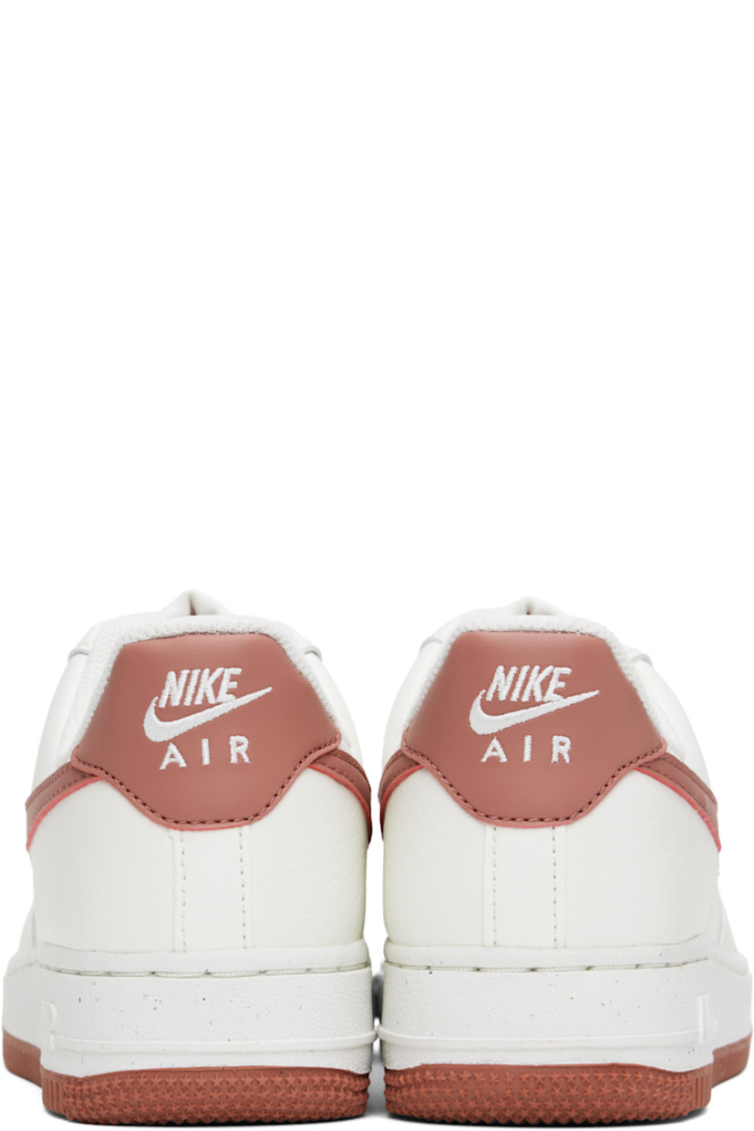 Low-top buffed leather sneakers in white and pink.

· Perforated detailing at toe and sides
· Logo plaque at lace-up closure
· Logo patch at tongue
· Padded collar
· Swoosh appliqué at sides
· Logo embroidered at heel tab
· Mesh lining
· Logo embossed at foam rubber midsole
· Treaded rubber sole

Please note that this item may be shipped only within North America.

Supplier color: Sail/Canyon pink