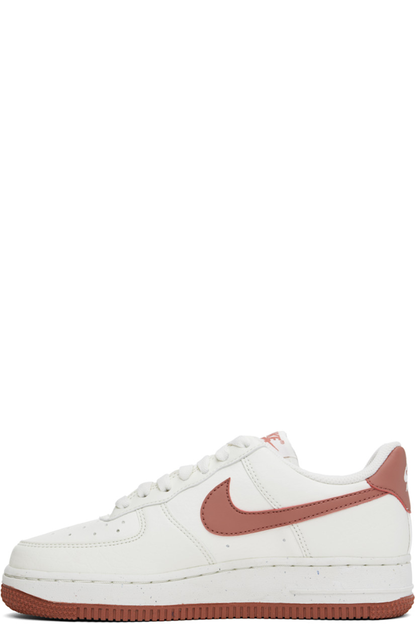 Low-top buffed leather sneakers in white and pink.

· Perforated detailing at toe and sides
· Logo plaque at lace-up closure
· Logo patch at tongue
· Padded collar
· Swoosh appliqué at sides
· Logo embroidered at heel tab
· Mesh lining
· Logo embossed at foam rubber midsole
· Treaded rubber sole

Please note that this item may be shipped only within North America.

Supplier color: Sail/Canyon pink